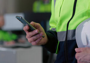 Worker holding a phone for Google Ads for Contractors